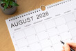© Marinela - August 2026 calendar month on a wooden background. Top view.