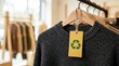 © DailyLens Studio - Recyclable material clothing featuring a green recycle tag in an eco-friendly retail shop.