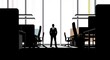© Shazzad - Professional standing in a modern office with large windows