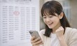 © rimosuke - スマートフォンで合格発表を見て喜ぶ若い女性の歓喜の瞬間