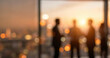 © Vhagar - Silhouettes of business people engaged in conversation against a backdrop of a city skyline at sunset, creating a warm, professional atmosphere.