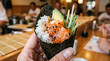 © Eni - Exquisite salmon hand roll with fresh avocado and cucumber to celebrate national hand roll day