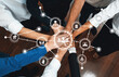 © InfiniteFlow - Group of diverse office worker join hand together in office room symbolize business synergy and strong productive teamwork in workplace. Cooperation and unity between business employee. Prudent Amity
