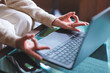 © Farknot Architect - Closeup image of a woman hands in lotus pose over laptop computer for stress relief concept