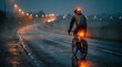 © Nusrat - Rear view of a cyclist with reflective gear riding bicycle on a wet road at night, showcasing safety lights and low visibility conditions.