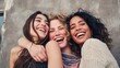 © Olya Pilipchik  - Three happy diverse women best friends embracing, laughing out loud together, showing genuine joy and friendship with bright smiles against a neutral background