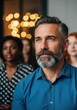 © Ariestia - Mature Professional Man Listening Attentively at a Business Conference Seminar with Diverse Audience