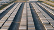 © Sekai - Large commercial delivery semi trailer fleet parked neatly in organized rows inside industrial logistics yard