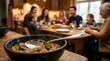 © world - Hot bowl of stew served on a table with a family dining in background
