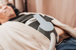 © Mdv Edwards - Middle-aged man undergoing HIFEM body contouring treatment on the abdomen, using high-intensity focused electromagnetic technology for muscle strengthening and body sculpting.