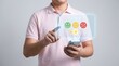 © Nazlen - Man in pink shirt giving feedback on mobile phone with emoticons and star ratings on screen, expressing satisfaction or dissatisfaction with service or product on gray background.