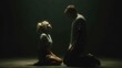 © 4kclips - Relationship conflict and emotional distress between a couple. A man and a woman are kneeling in a dark, low key setting, facing each other with expressions of sadness and despair.