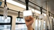 © Pinit - Hand grasping a transparent grab bar handle in an airport shuttle or city bus interior.