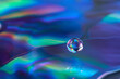 © Yaroslav Danylchenko/Stocksy - Iridescent water drop on holographic CD surface