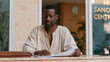 © forenna - Ghanaian former bank manager in worn clothing collecting unemployment documents at government office, briefcase still polished out of habit, job loss dignity, white-collar