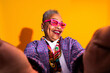© oneinchpunch - Senior woman smiling taking a colorful selfie - Old hispanic grandmother wearing fashionable modern clothing on colorful background, concepts about elderly, aging, diversity