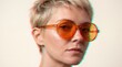 © Rhayron - A stylish young woman with short hair wearing orange-tinted sunglasses, presented with a modern digital glitch and chromatic aberration artistic effect.