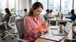 © MOH - Cropped shot of woman holding painful wrist with red glow over desk for carpal tunnel syndrome