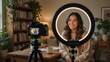 © Iswanto - Smiling woman recording video blog with ring light in cozy home setting