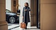 © Владимир Platon - A stylish business woman in a grey coat standing outside a luxury hotel entrance, looking at her wrist watch while waiting for her car