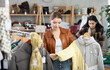 © JackF - Girl near showcase examine goods, buying down jacket. Off line clothing store from retailer. Style and fashion type look, modern trends. Designer clothing store, vintage fashion, limited edition
