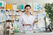 © JackF - Young woman pharmacist offers cosmetics for makeup in pharmacy