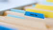 © photo for everything - A close-up view of file folders with a blue tab labeled 'Estate Plan' prominently displayed, suggesting organization and important documentation