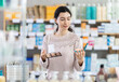 © JackF - Young woman in sweater choosing cosmetic products in a European pharmacy