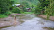 © Farknot Architect - Portrait image of a woman standing by the river in rural village and looking at a beautiful nature