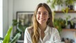© Umer - Woman with long hair smiles towards the camera while standing in a cozy room filled with various potted green plants.