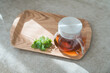 © buritora - A tray and teapots containing black tea and herbal tea are placed on the sofa.