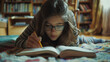 © Muhammad - A focused young girl with glasses immersed in her creative pursuits, diligently drawing in an open book while comfortably relaxing on a patterned rug at home