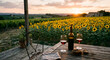 © Kate Y - Romantic sunset wine tasting with red wine on a rustic wooden table overlooking a sunflower field and vineyard.