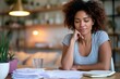 © TAlex - Calm woman organizing loan statements with notebook at home