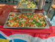 © JADA - Metal bowls filled with boiled carrots, cauliflower, and green beans are served on a wooden table.