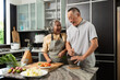 © Prot - Elderly couple chopping vegetables together in kitchen, representing family bonding, healthy lifestyle, and wellness in cozy indoor environment with natural daylight, modern design, and cheerful