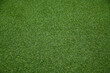© awgraphoto - A top-down full frame view of uniform vibrant green artificial grass turf texture.
