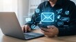 © Abbas - Man using smartphone and laptop for email communication