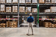 © Rawpixel.com - Man in warehouse inspecting shelves filled with boxes and pallets.