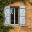 © KIMOG - Old Window with Open Blue Wooden Shutters on Rustic European House Facade