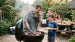 © Felippe Lopes - Father and son enjoy a backyard barbecue with family and friends on a summer evening