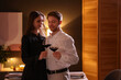 © New Africa - Date. Lovely couple with glasses of red wine at home, space for text