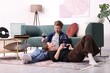© New Africa - Date. Couple with glasses of wine listening to vinyl record at home