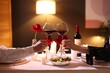 © New Africa - Date. Couple clinking glasses of red wine at table indoors, closeup