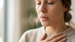 © Elenba - Close up of woman exhaling visible breath with hand on chest. Mindfulness and deep breathing concept