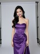 © miss irine - Elegant Asian woman wears a strapless purple gown. She smiles gently posing for a studio photoshoot. Long dark wavy hair and sparkling earrings complete her glamorous look.
