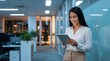 © Ben design - Latin Hispanic mature adult professional business woman looking at online trade app. European businesswoman CEO holding digital tablet using fintech tab application standing at workplace in office.