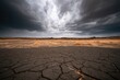 © gerald - Arid, cracked earth under a dramatic, storm-laden sky