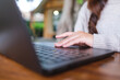 © Farknot Architect - Closeup image of a woman working and touching on laptop computer touchpad