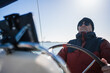 © Nazareno - Mature man steering sailing boat on sunny day